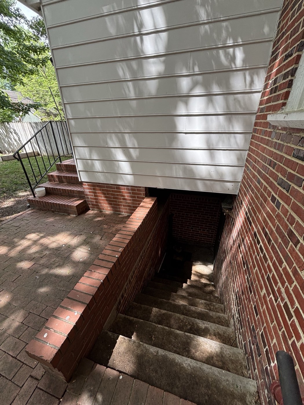 Basement stairwell cleared of leaves after cleanup
